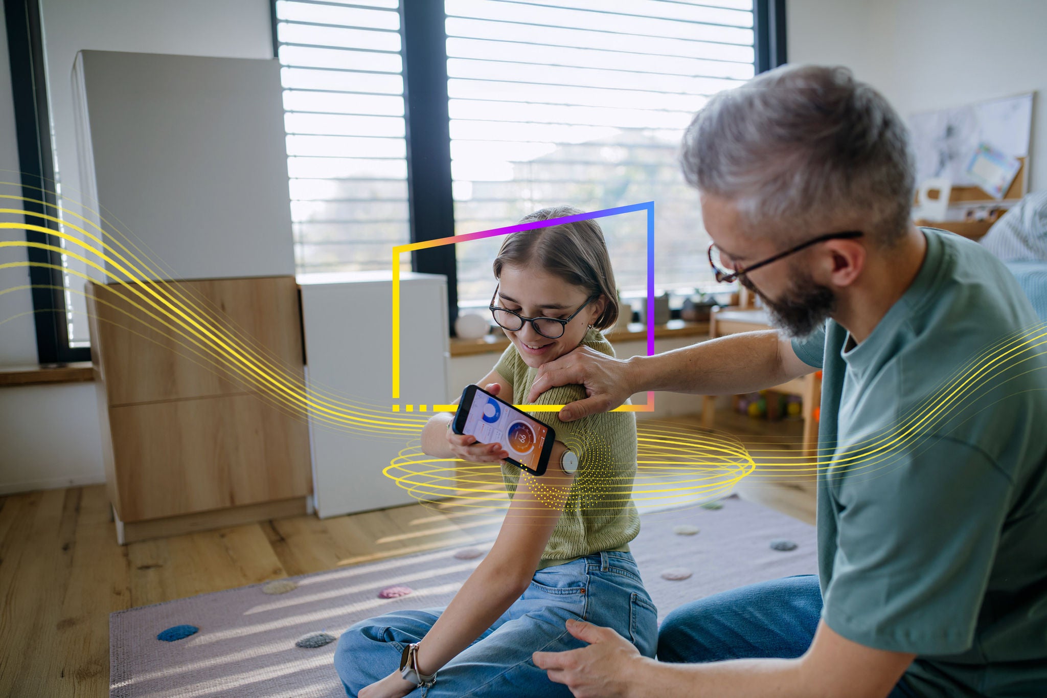 Diabetic girl with a CGM sensor on her arm. Father using an app to monitor blood sugar levels.