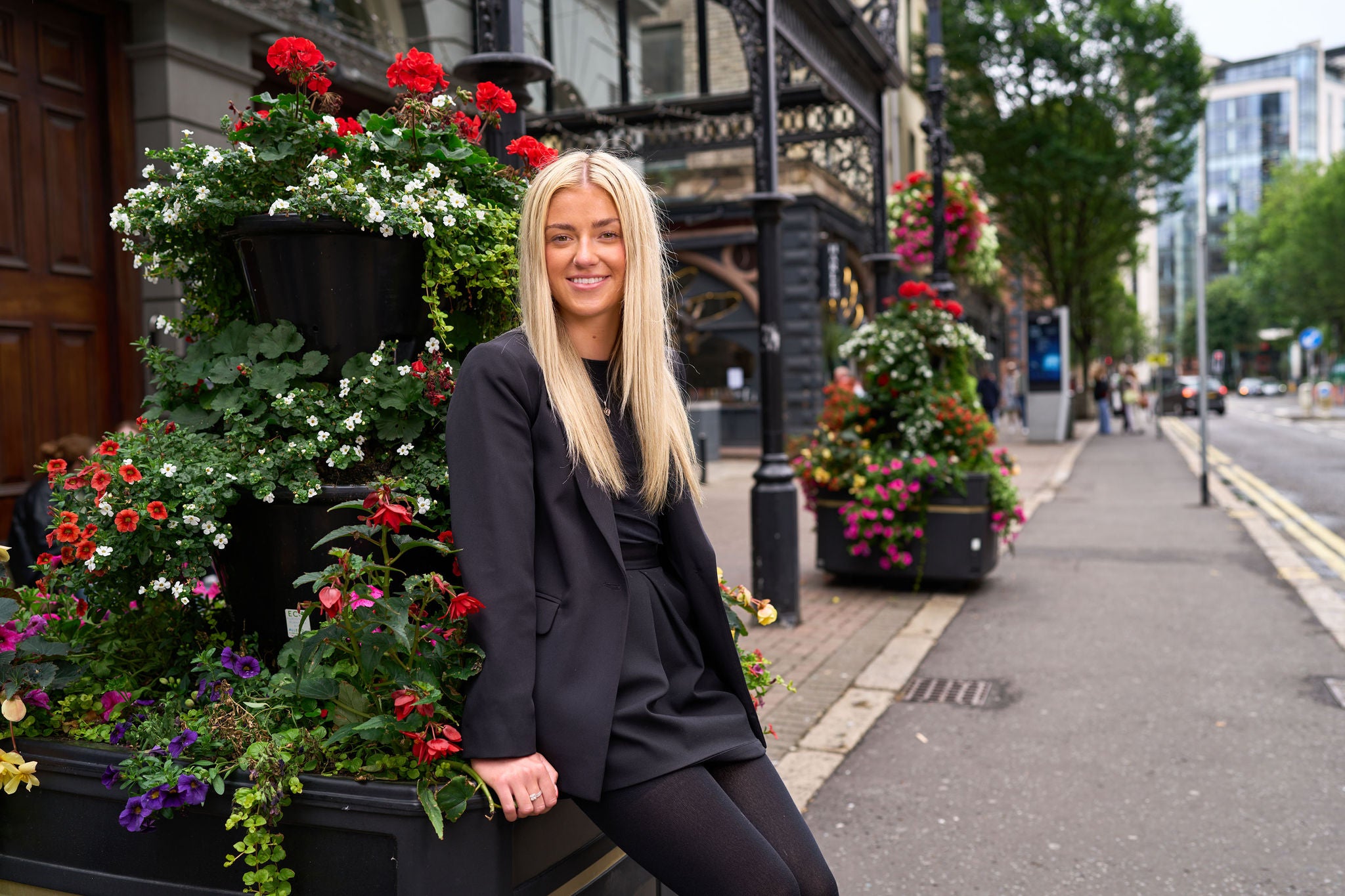 Person sitting next to flowers