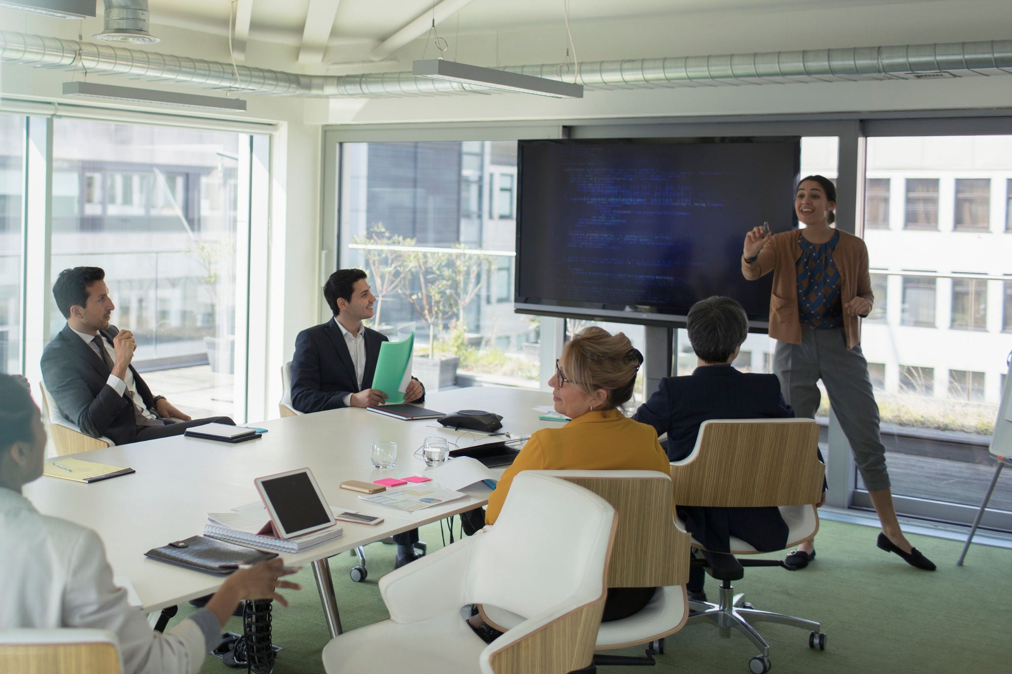 Businesswoman leading conference room meeting