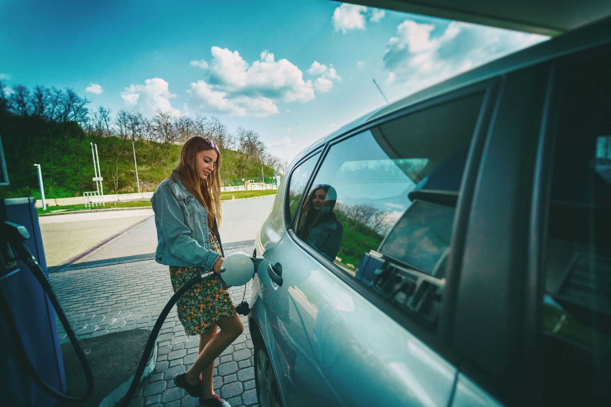 Woman refilling car gas pump