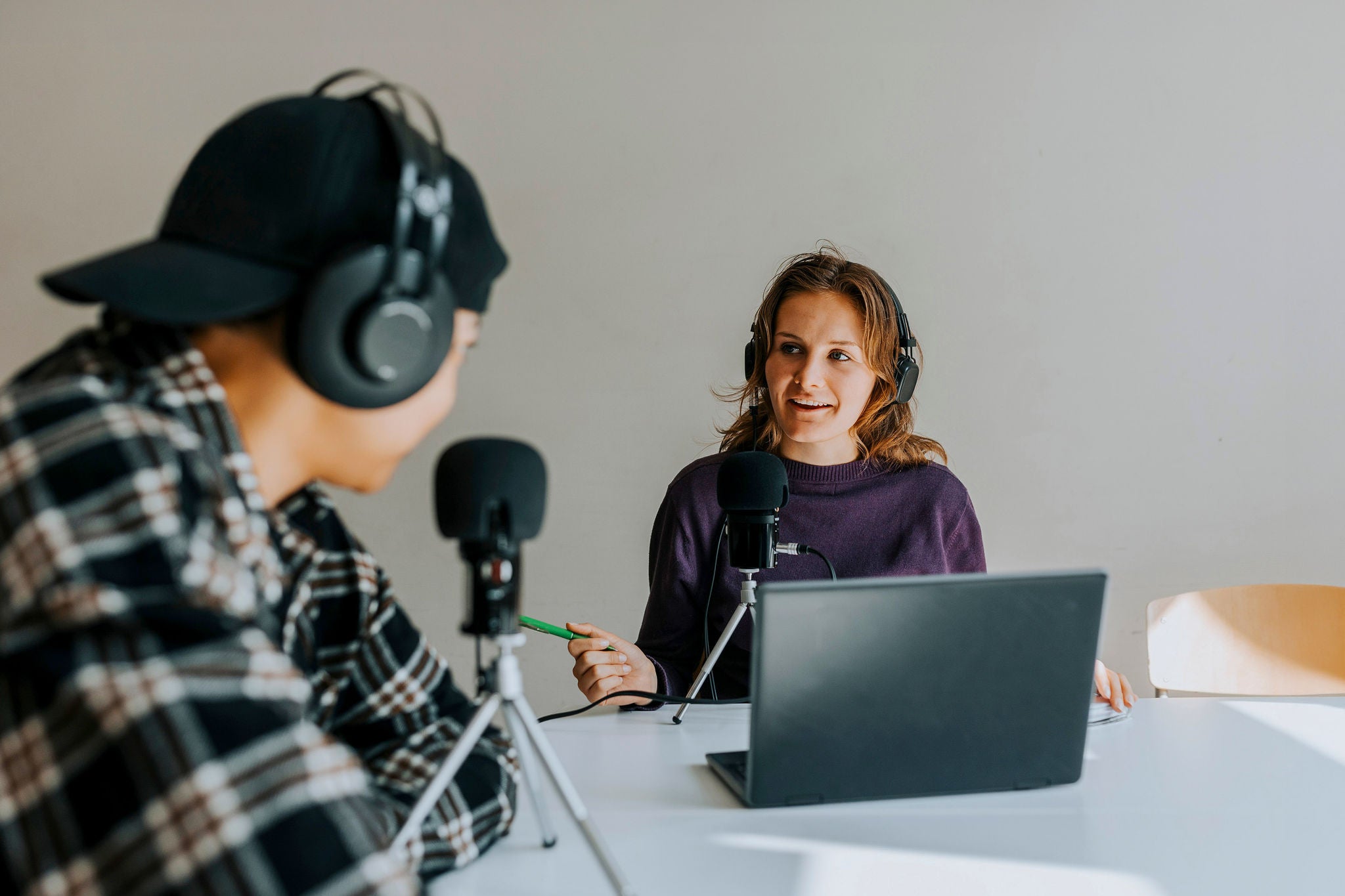 Two young man and women talking together during podcast
