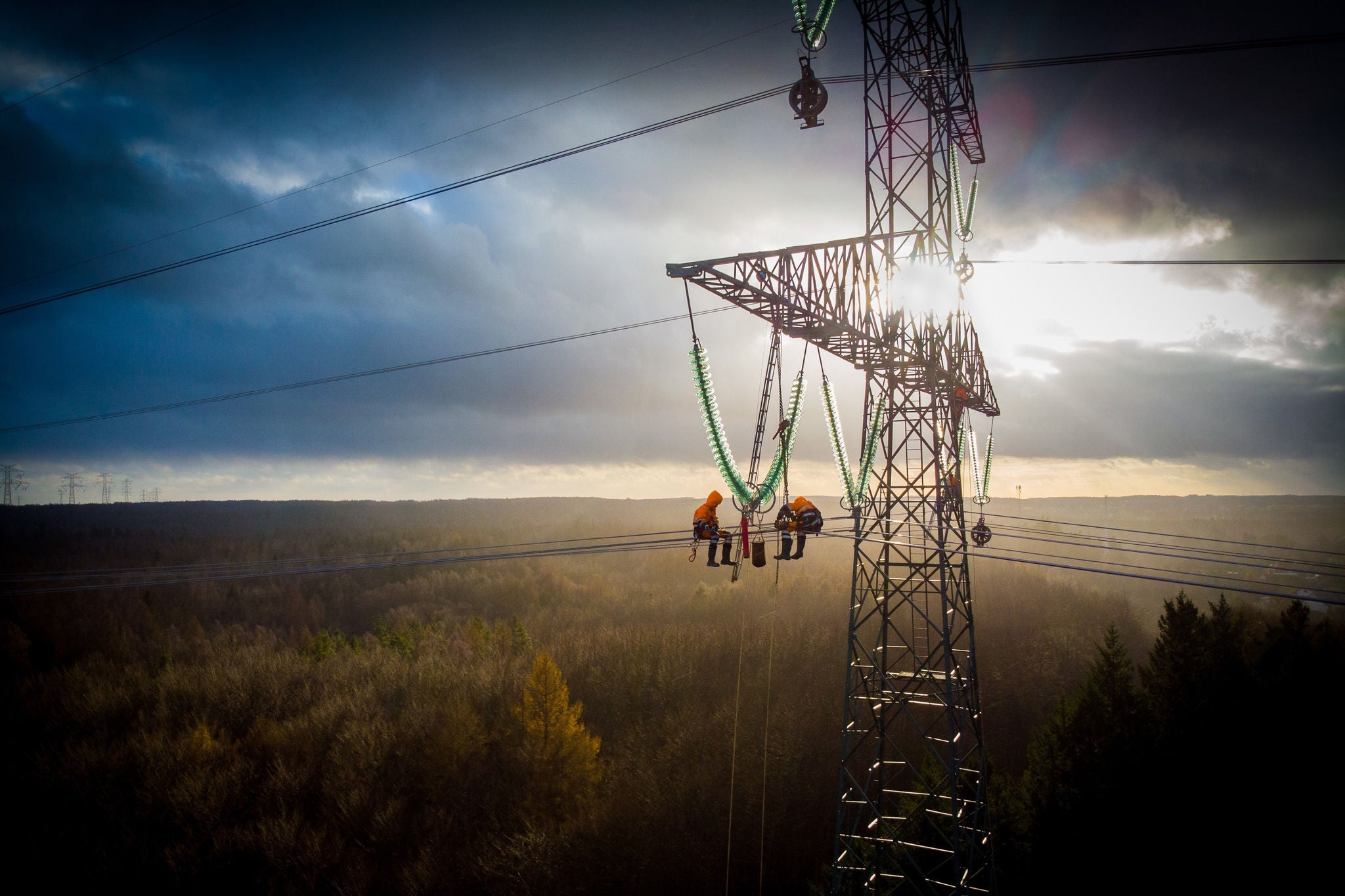 Aerial view of electricians working on electric poles