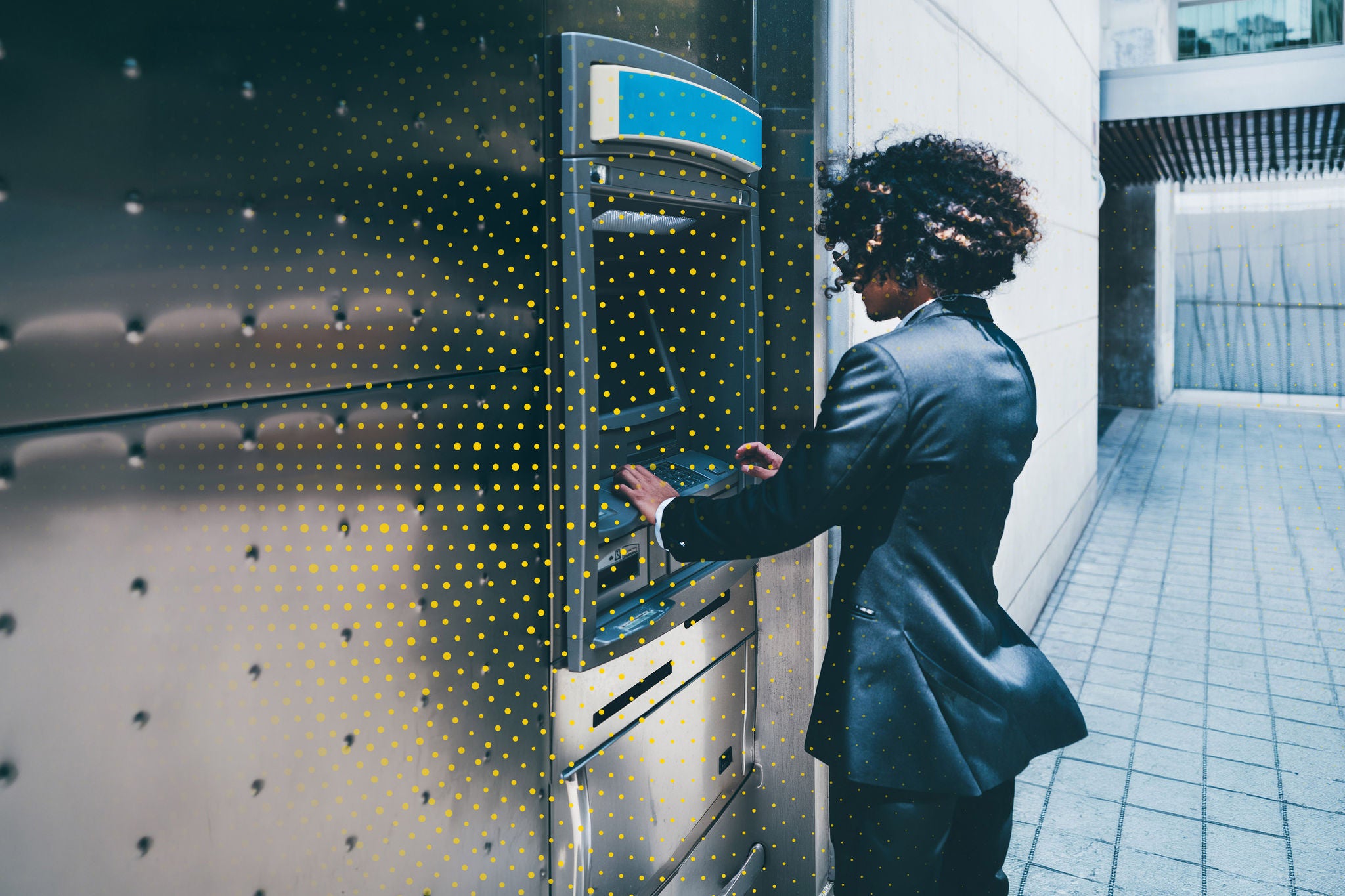 A woman using an ATM to withdraw cash