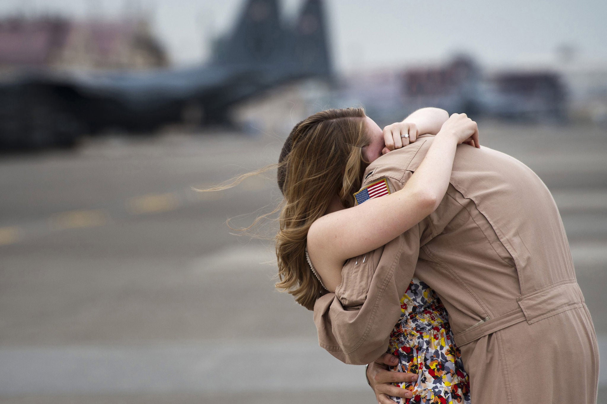 Chelsea Metros hugs her husband, Capt. George Metros, for the first time in four months at Yokota Air Base, Japan