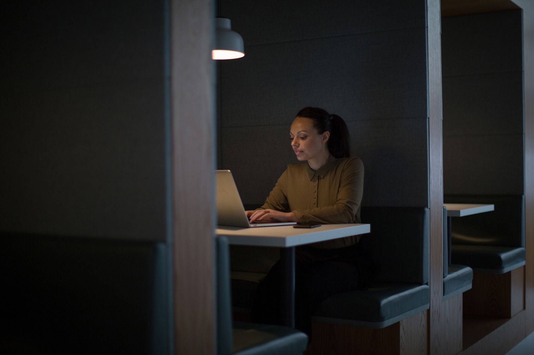 Businesswoman working late at night in office alone