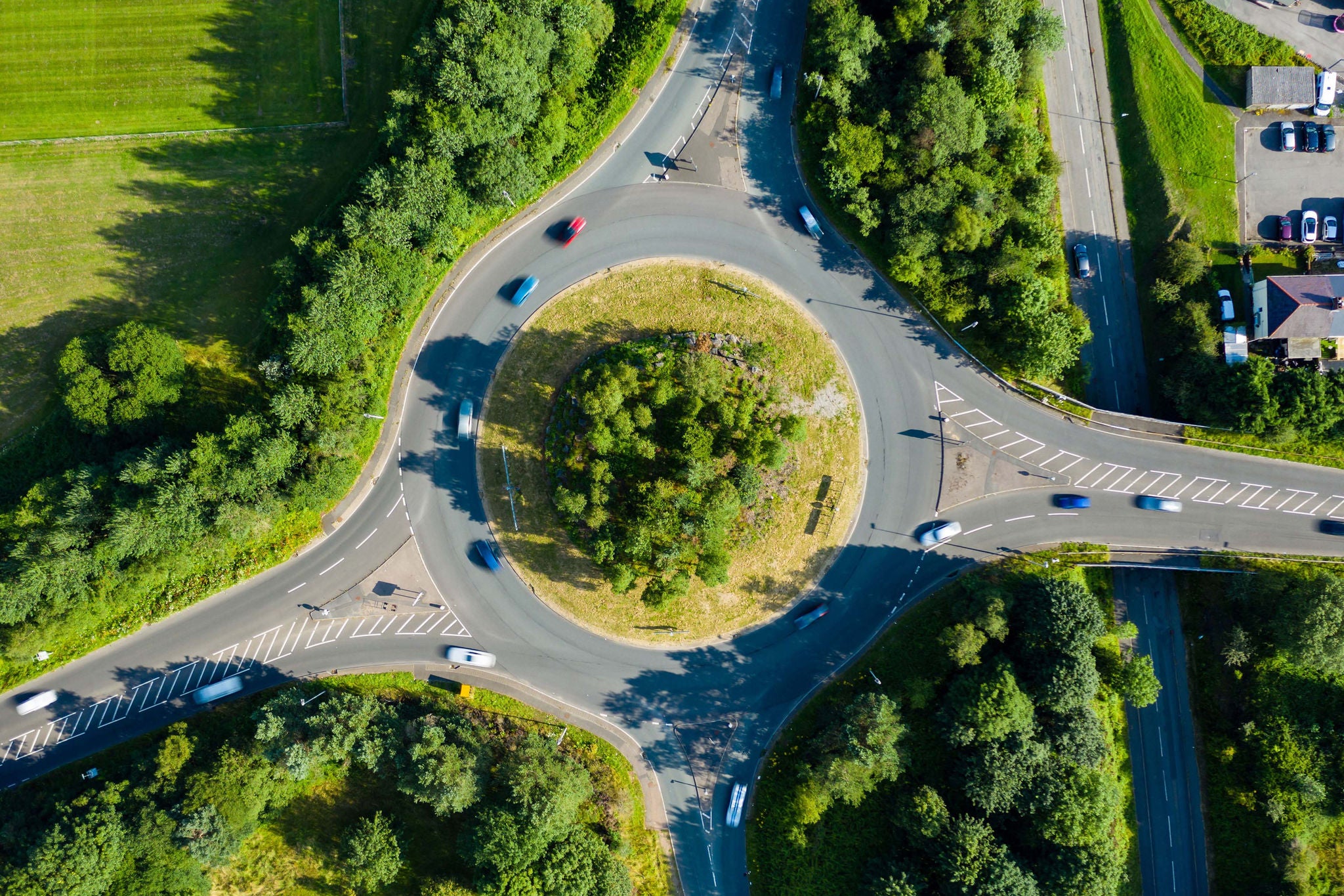 Aerial long exposure of traffic on a roundabout in a small town