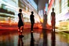 Man and woman looking at abstract cityscape being projected onto the wall in a gallery space