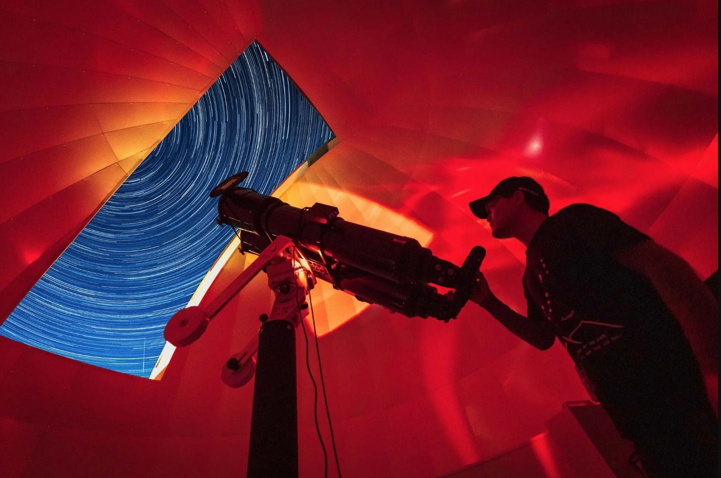 ey-astronomer-in-photo-telescope-dome-with-red-light