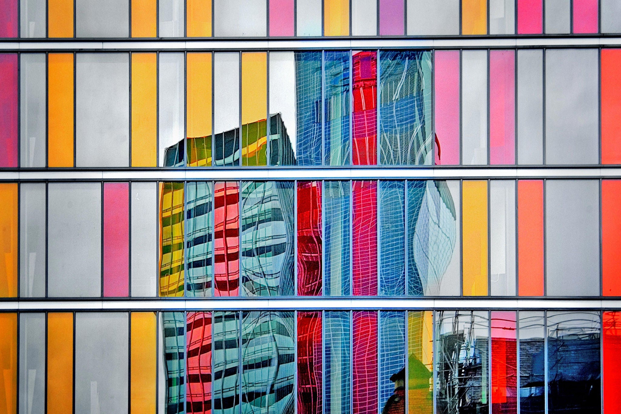 Colorful glass facade building reflection on modern architecture