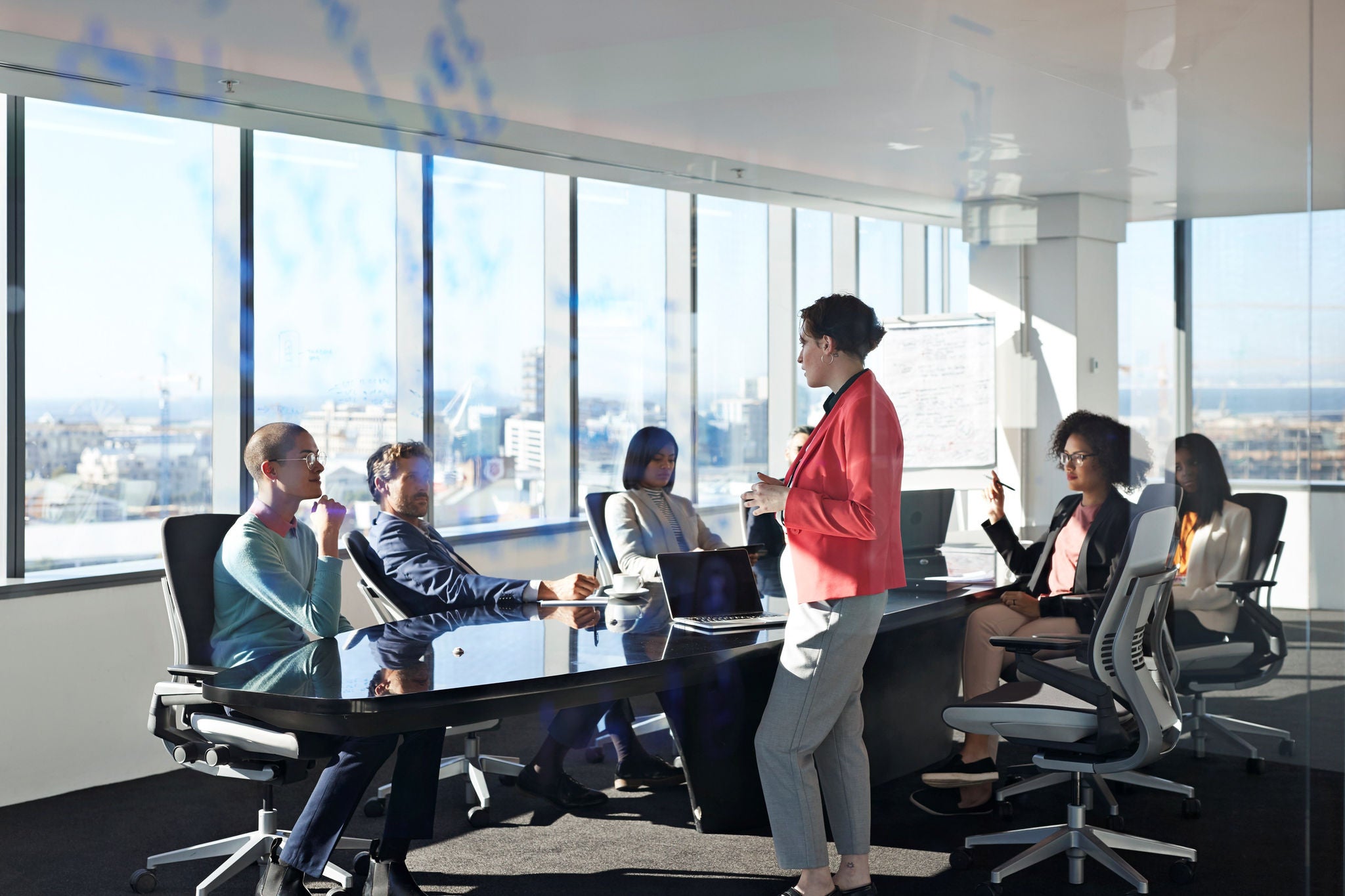 Strategy session unfolding in a modern, light‑filled conference room