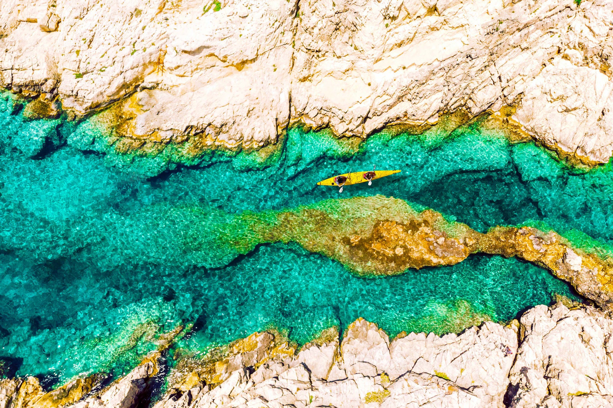 Directly above view of tandem kayak in transparent waters in greece background