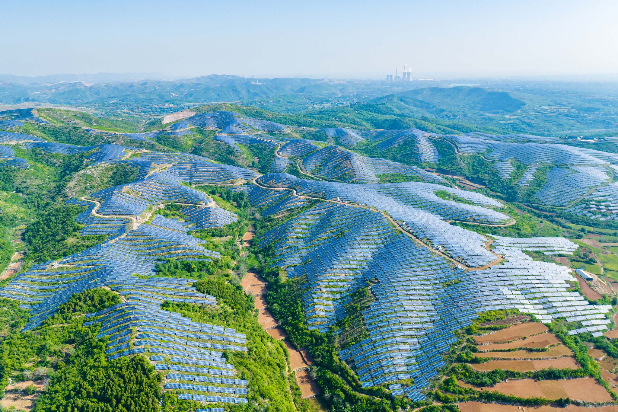 Aerial view of solar panels on the top of the mountain