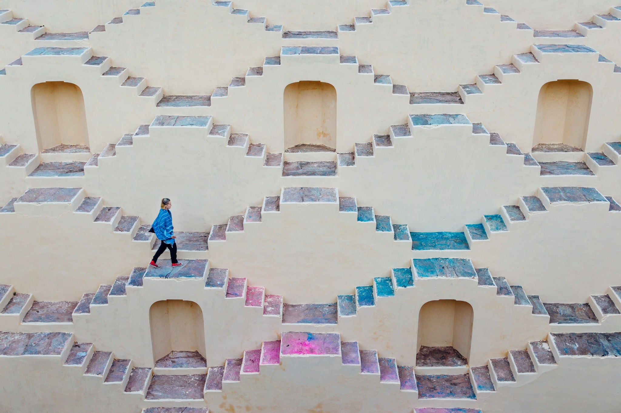 Photo of guy walking on a colorful staircase