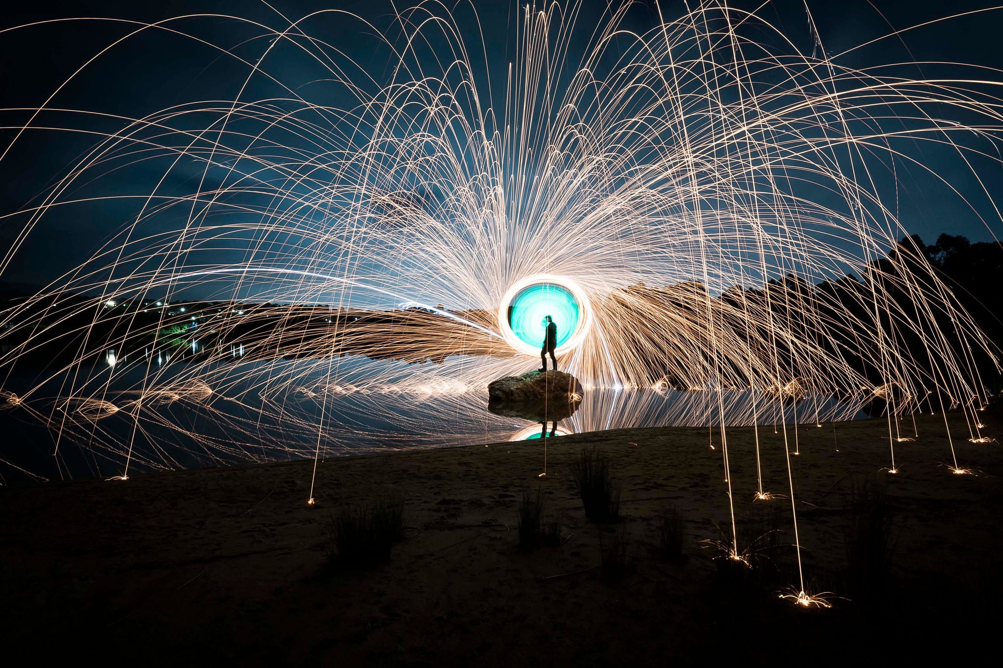 ey-silhouette-of-a-person-spinning-wire-wool-against-a-night-sky