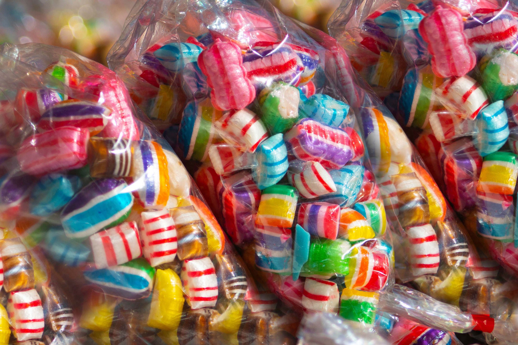 Colorful candies in plastic packaging OR Fresh chopped and chunks fruits plastic box