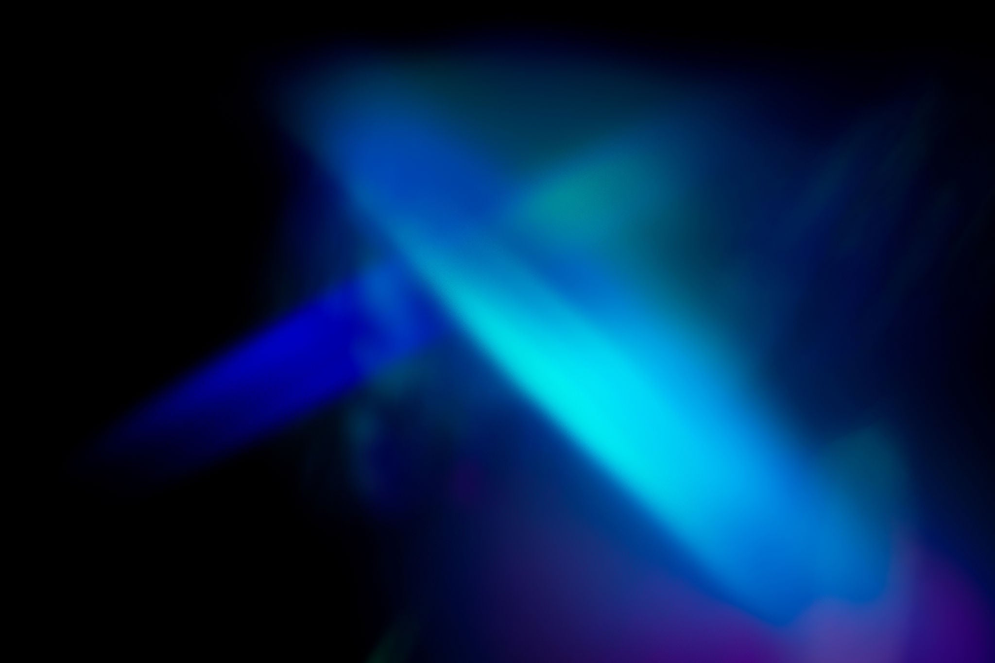 Abstract blue and teal light gradient on a dark background