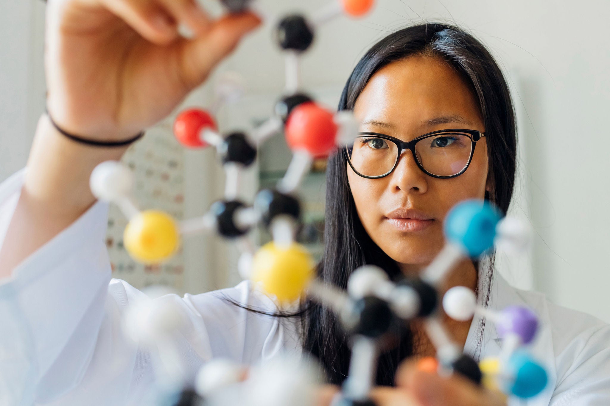 Scientist examining DNA model in laboratory