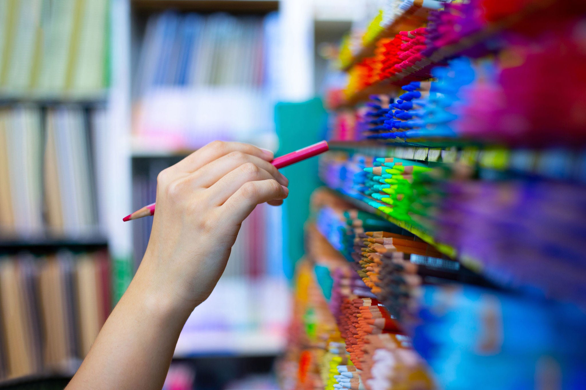 Shot of a hand selecting a colored pencil at art shop