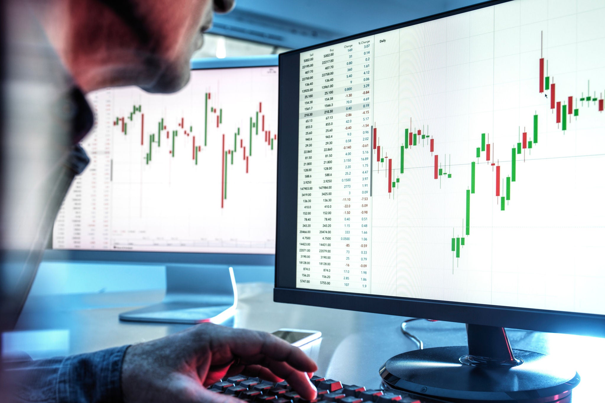 UK, Buckinghamshire, High Wycombe, Man examining graph on monitor