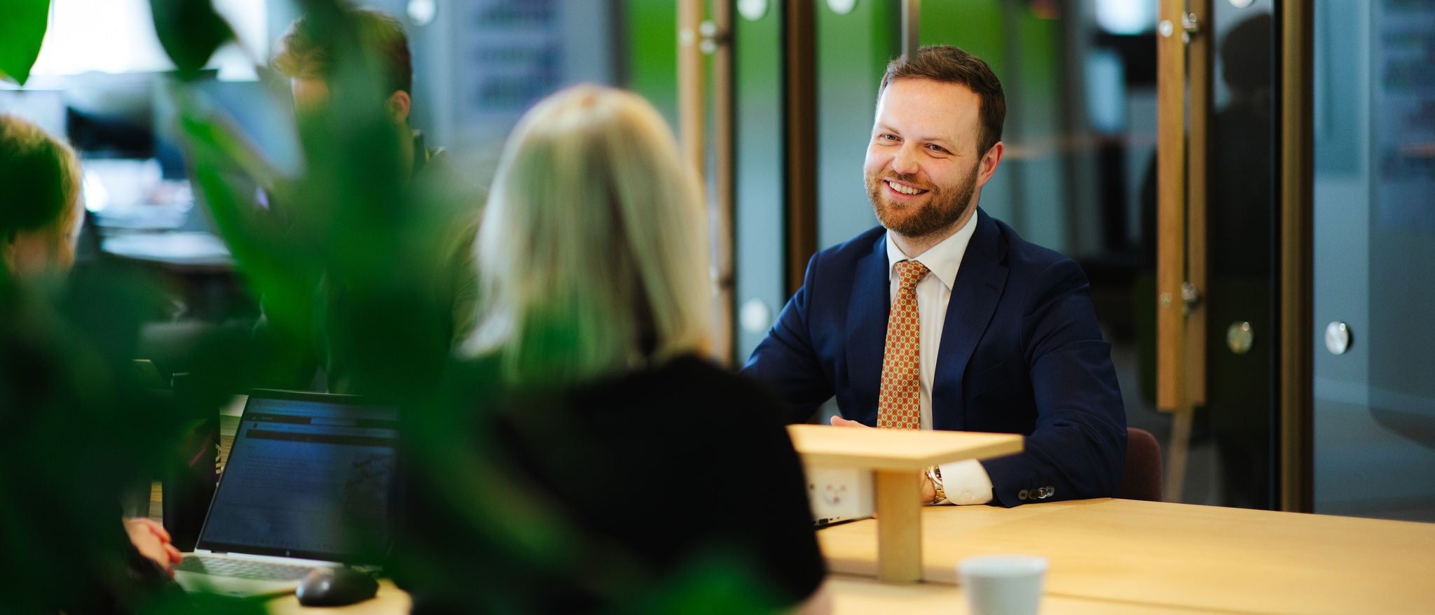 Professionals in meeting discussing work at modern office table
