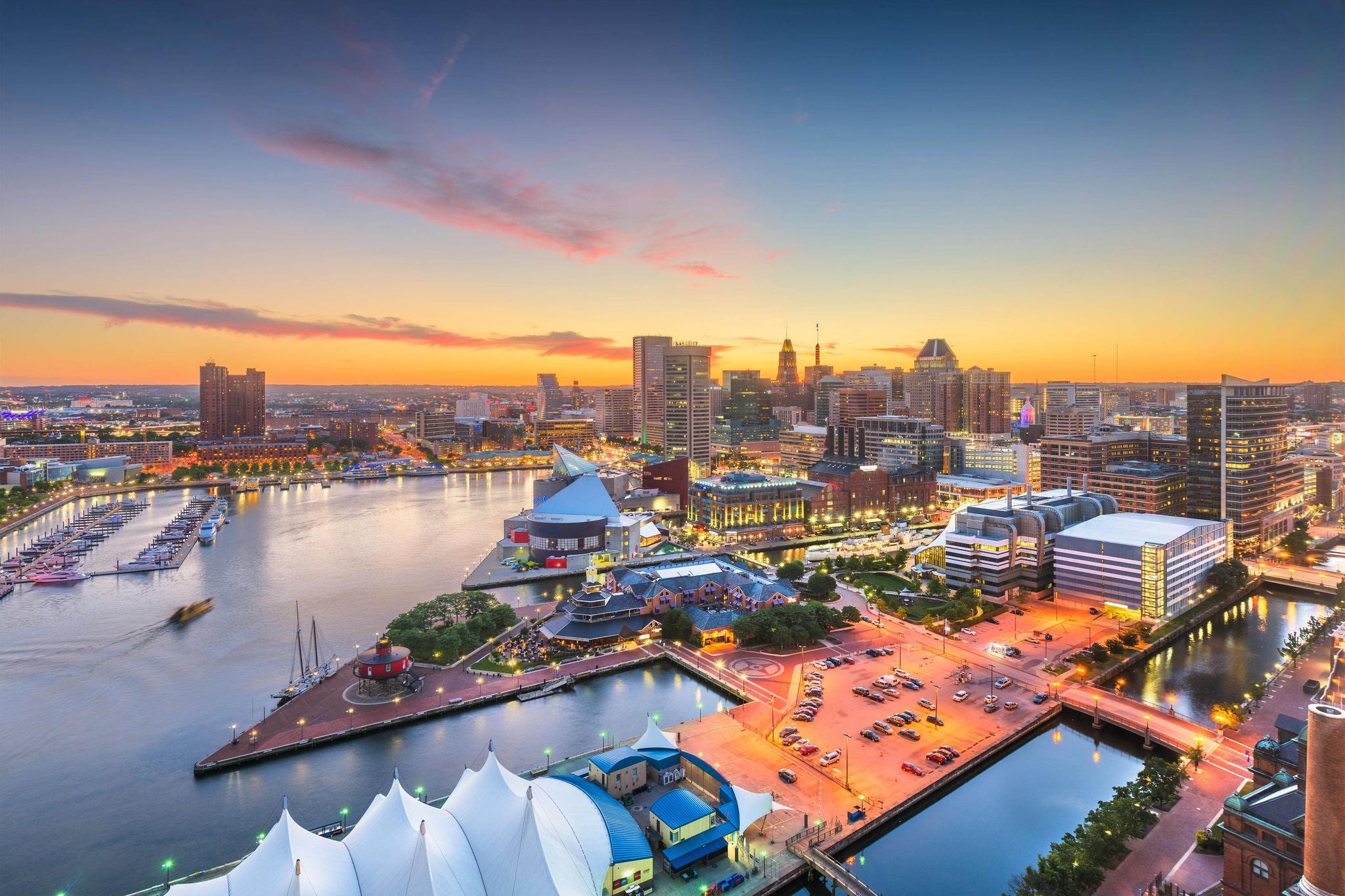 Baltimore, Maryland, USA city skyline over the Inner Harbor at twilight. 