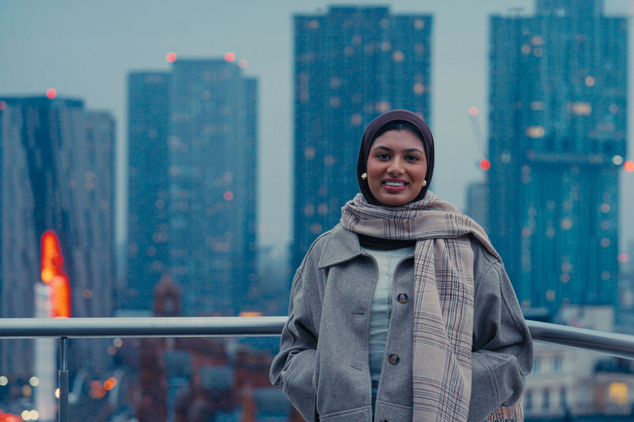 Person standing outside with a skyline backdrop