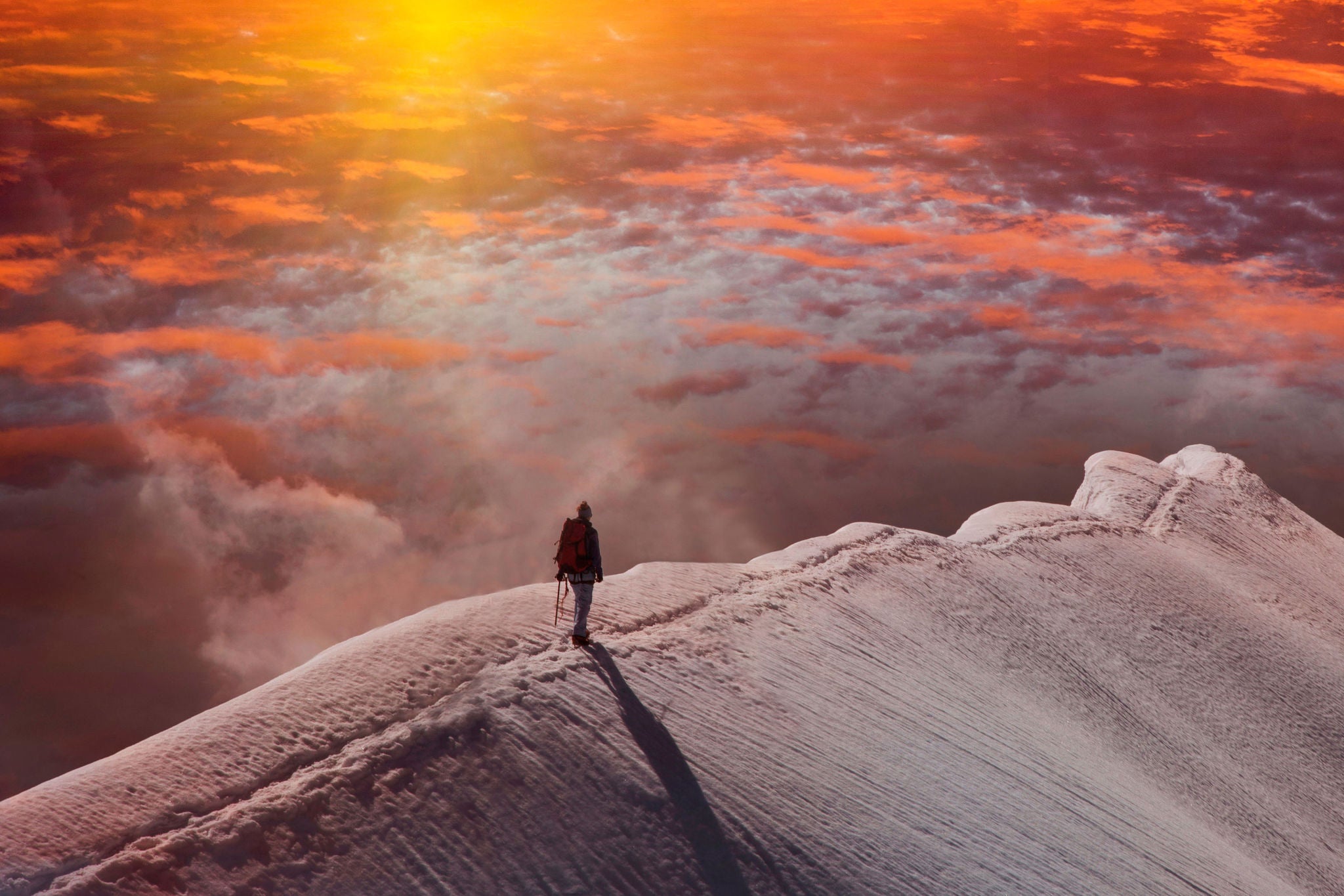 person on mountain at sunset
