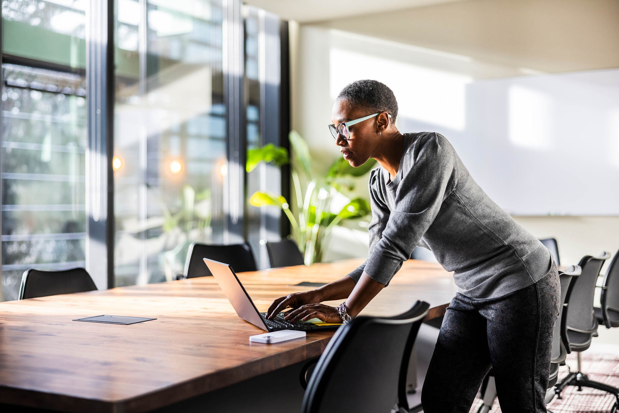Young businesswoman working on laptop in modern office room