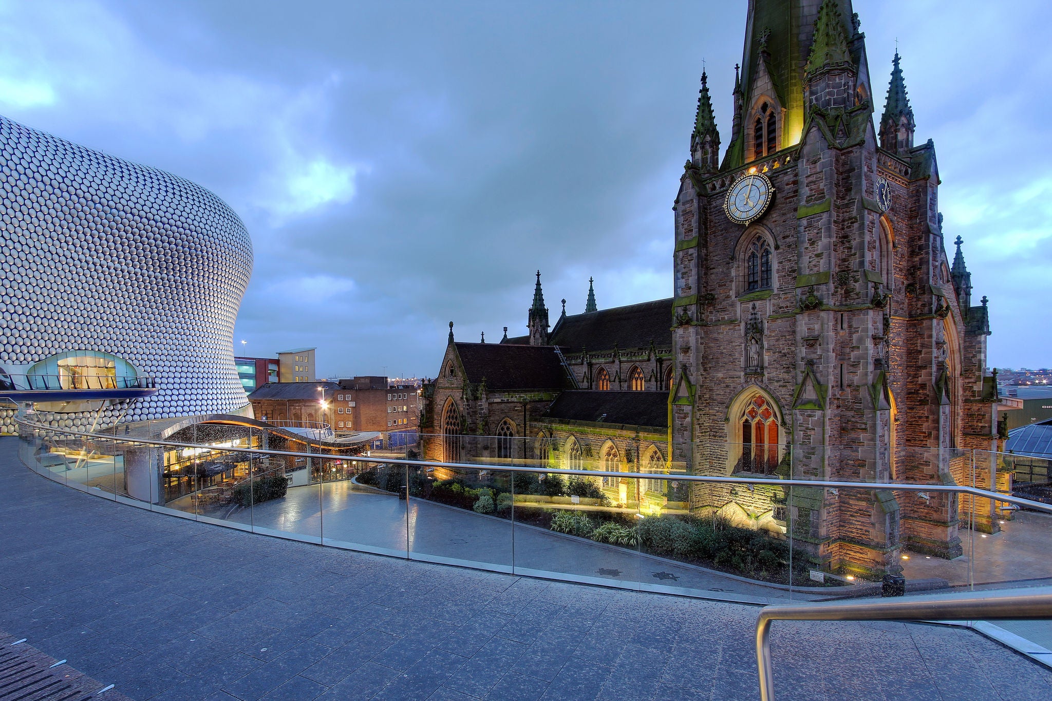 Historic church beside a modern building in city centre