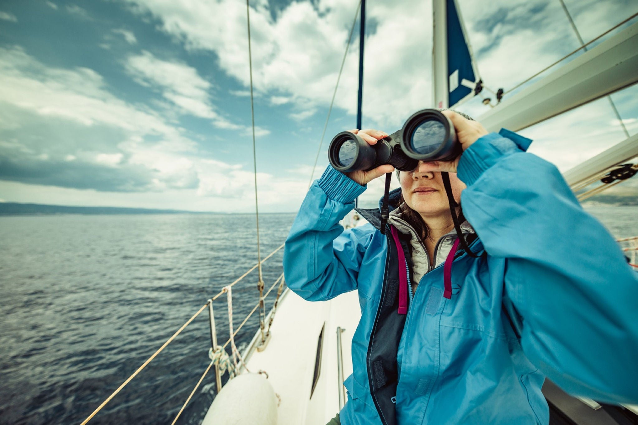 Woman on boat with binoculars