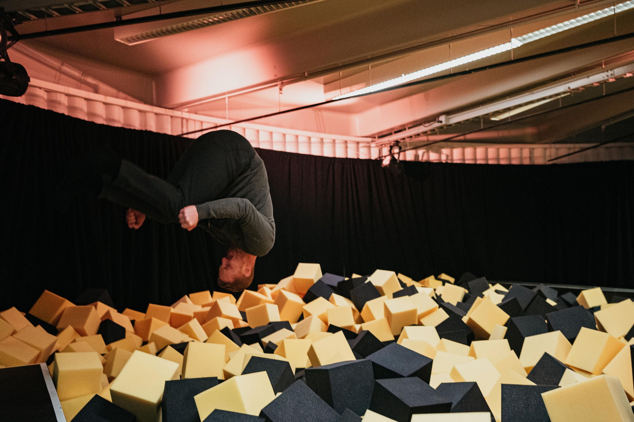 man flips into the foam pit at the EY Innovation Realized Global Summit