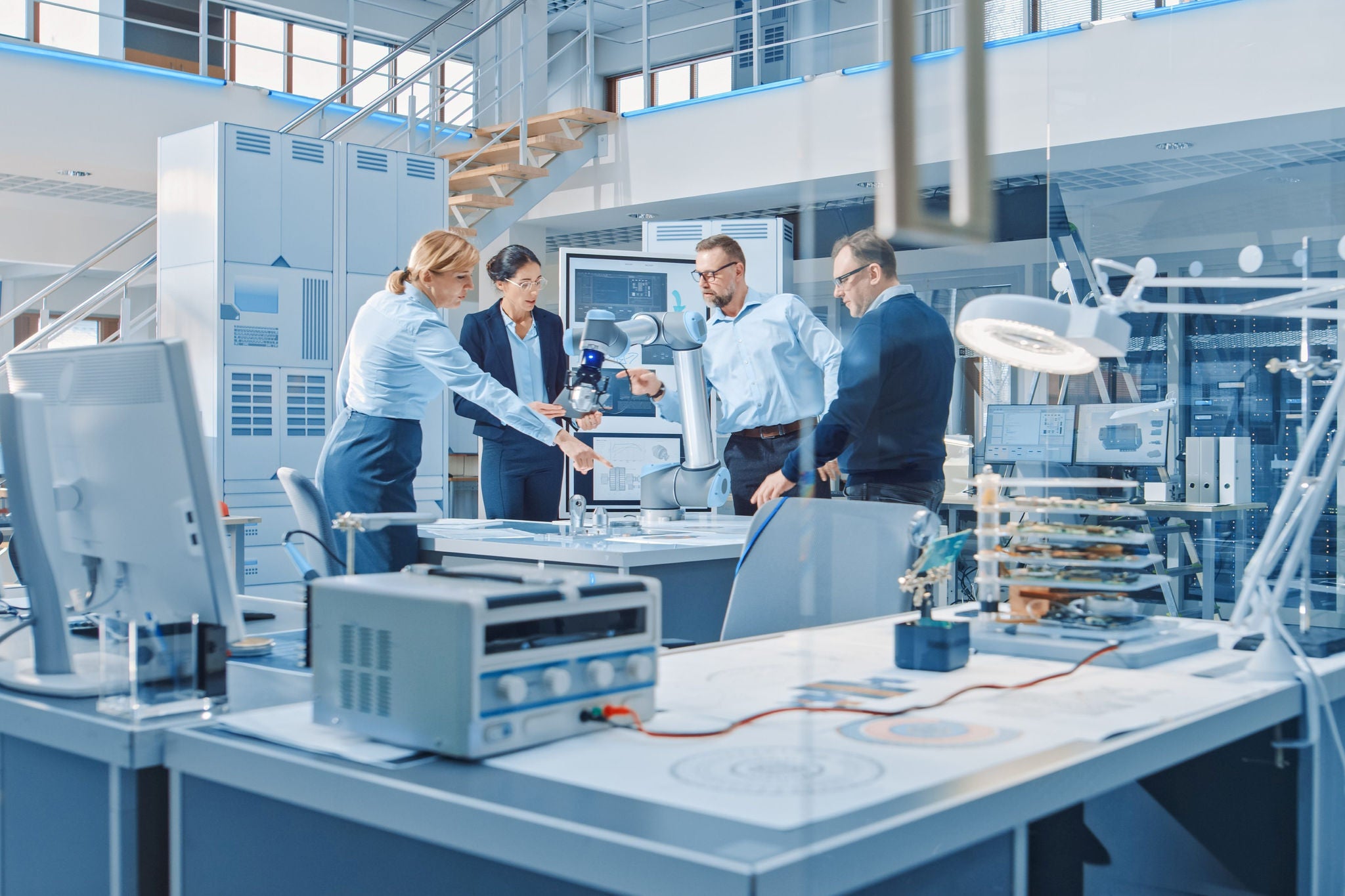 Industrial design engineers gathered around table