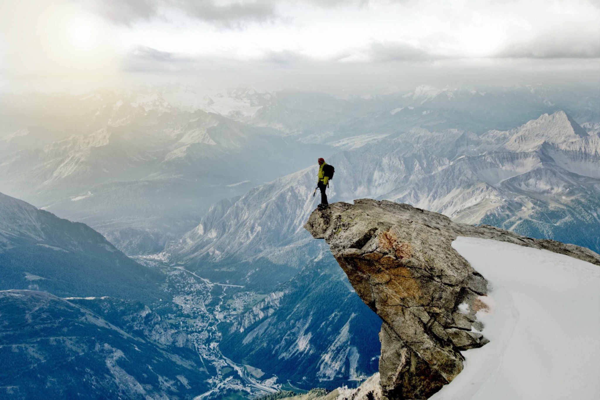 Ein Mann, der auf der Spitze eines gebogenen Steins steht