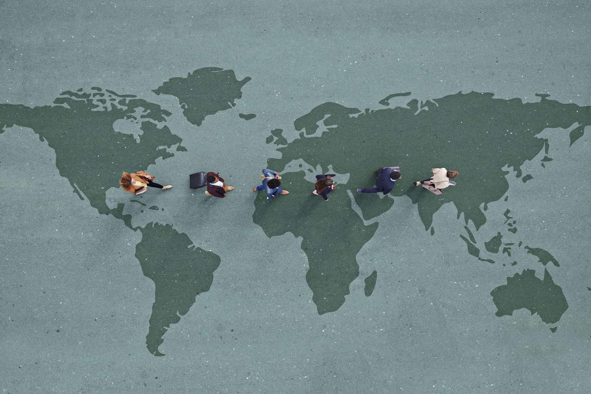 People walking across a world map illustration.