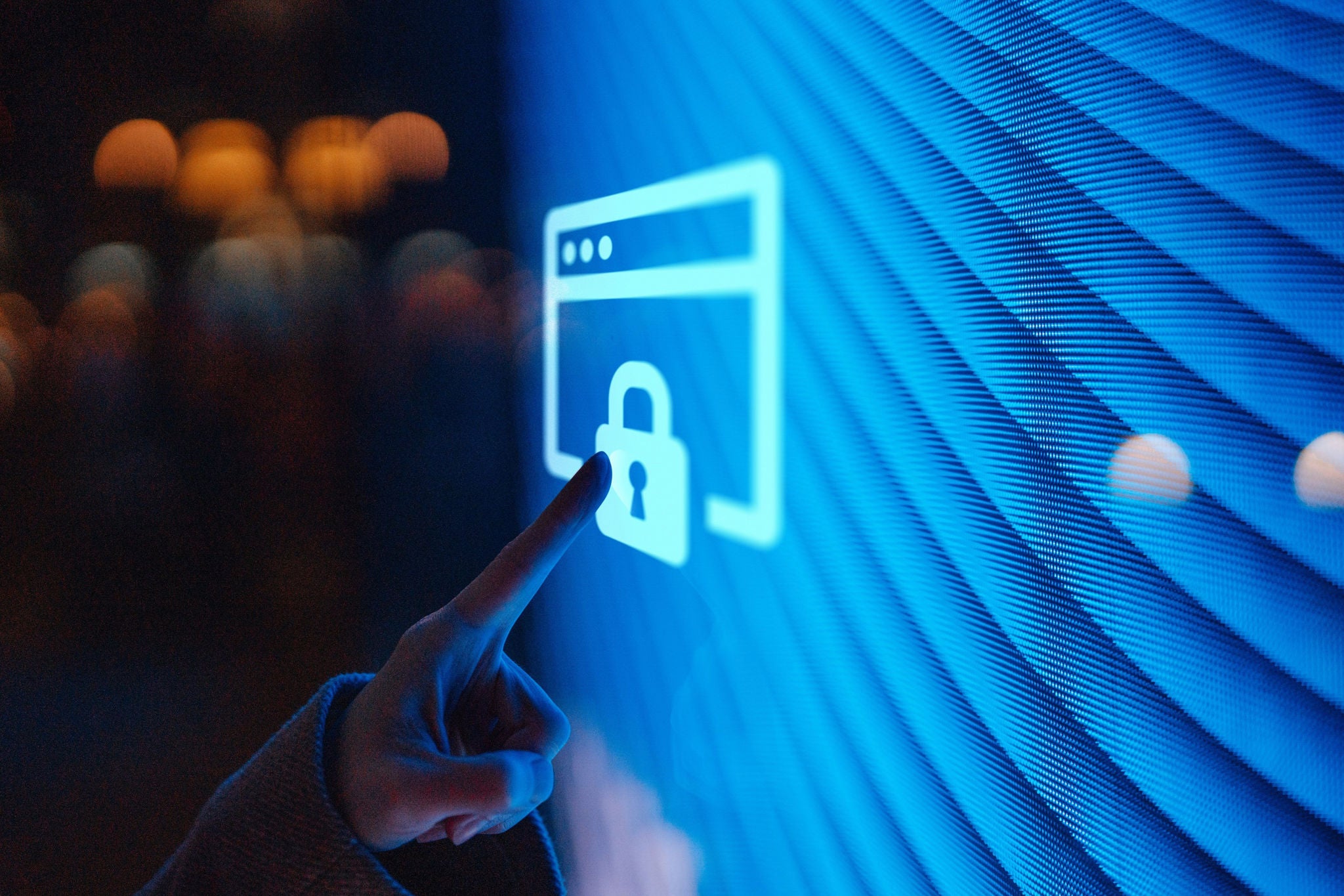 Close up of female hand touching illuminated digital screen displaying a locked sign