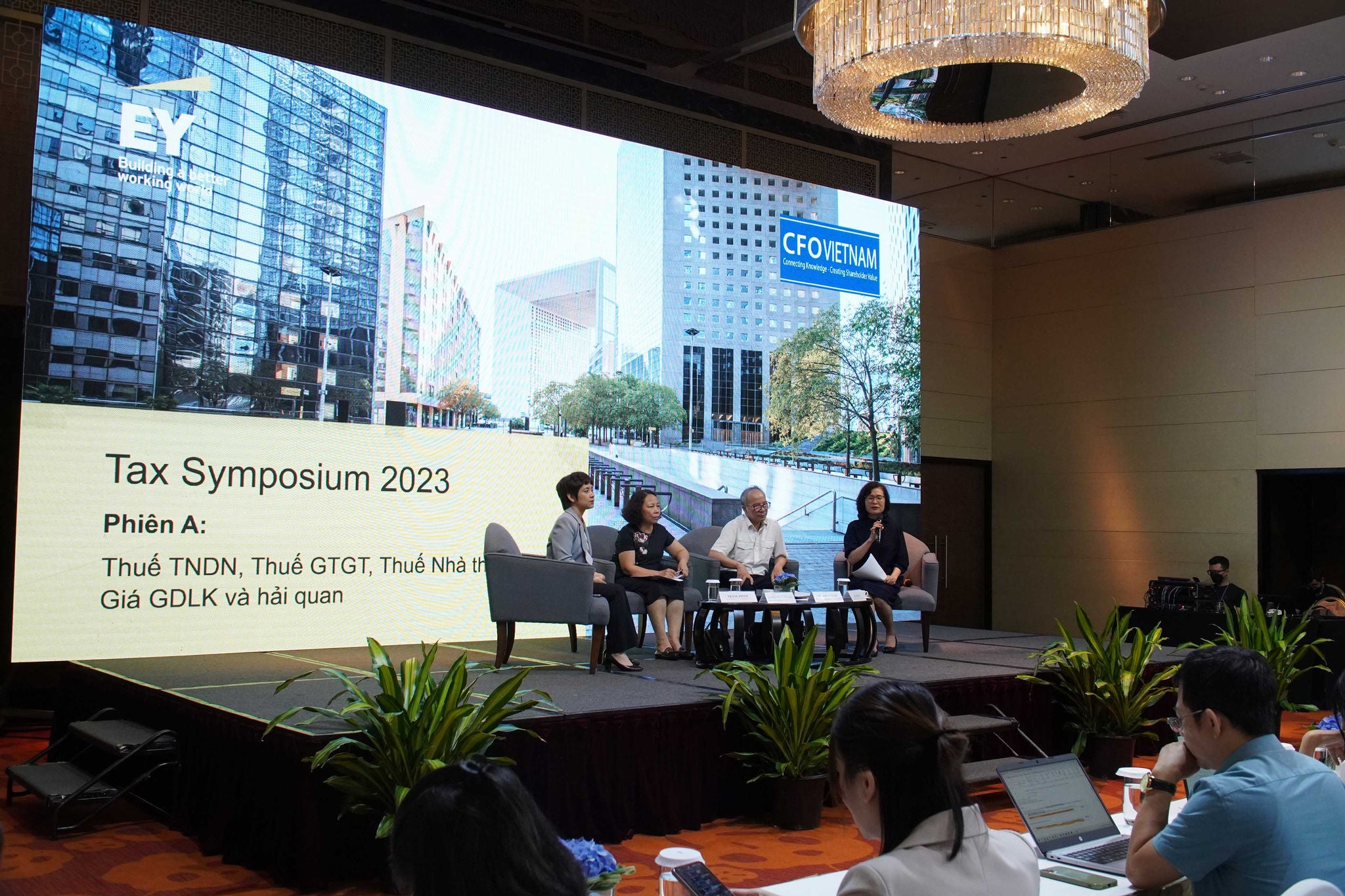 Business professionals sitting on stage
