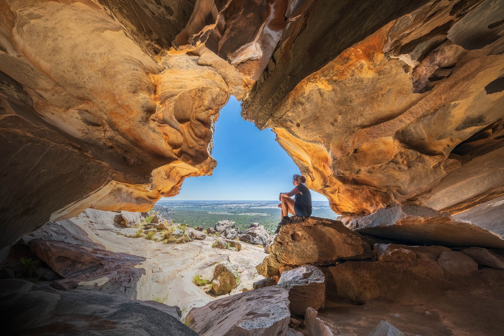 Female tourist relaxing inside hollow mountain