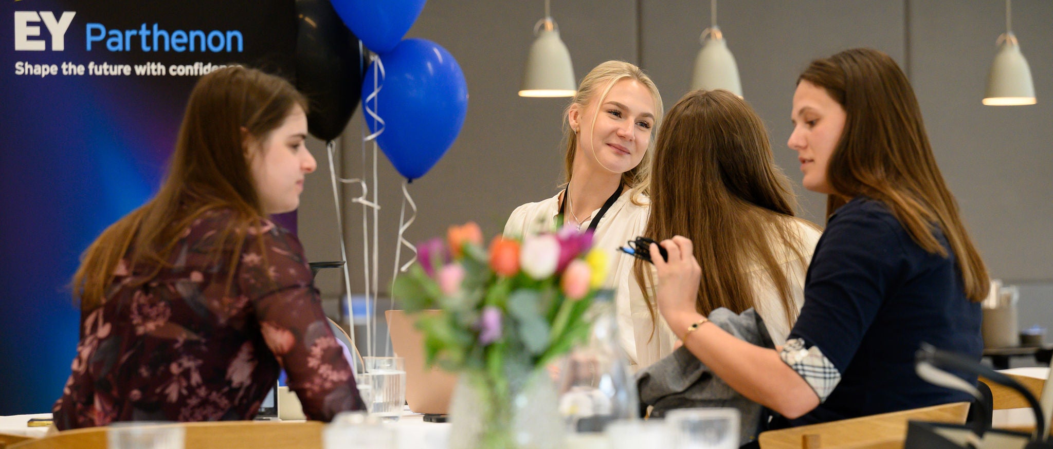 Women sitting around table at event