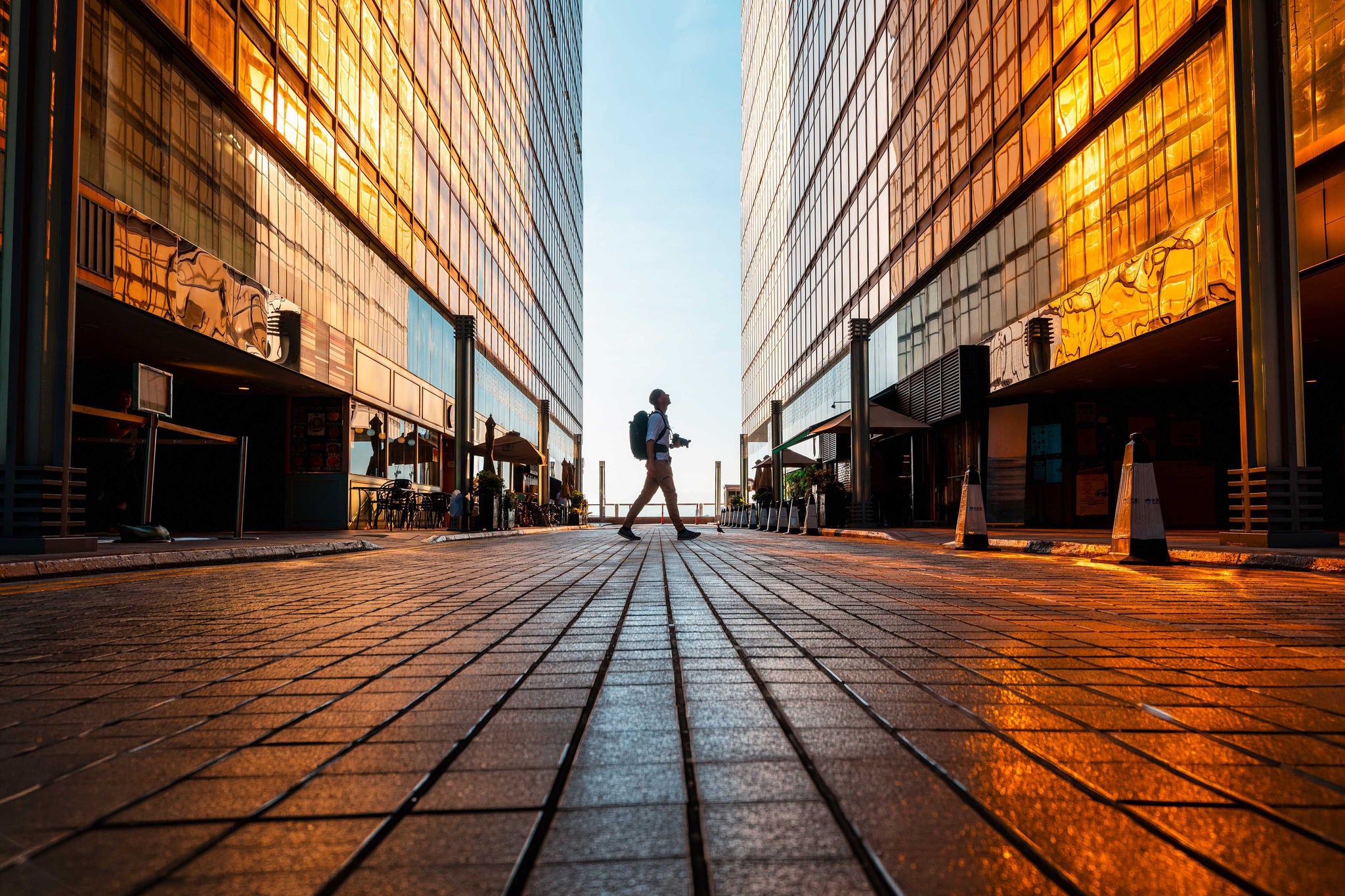 Tourist exploring Hong Kong among high rise buildings at sunset