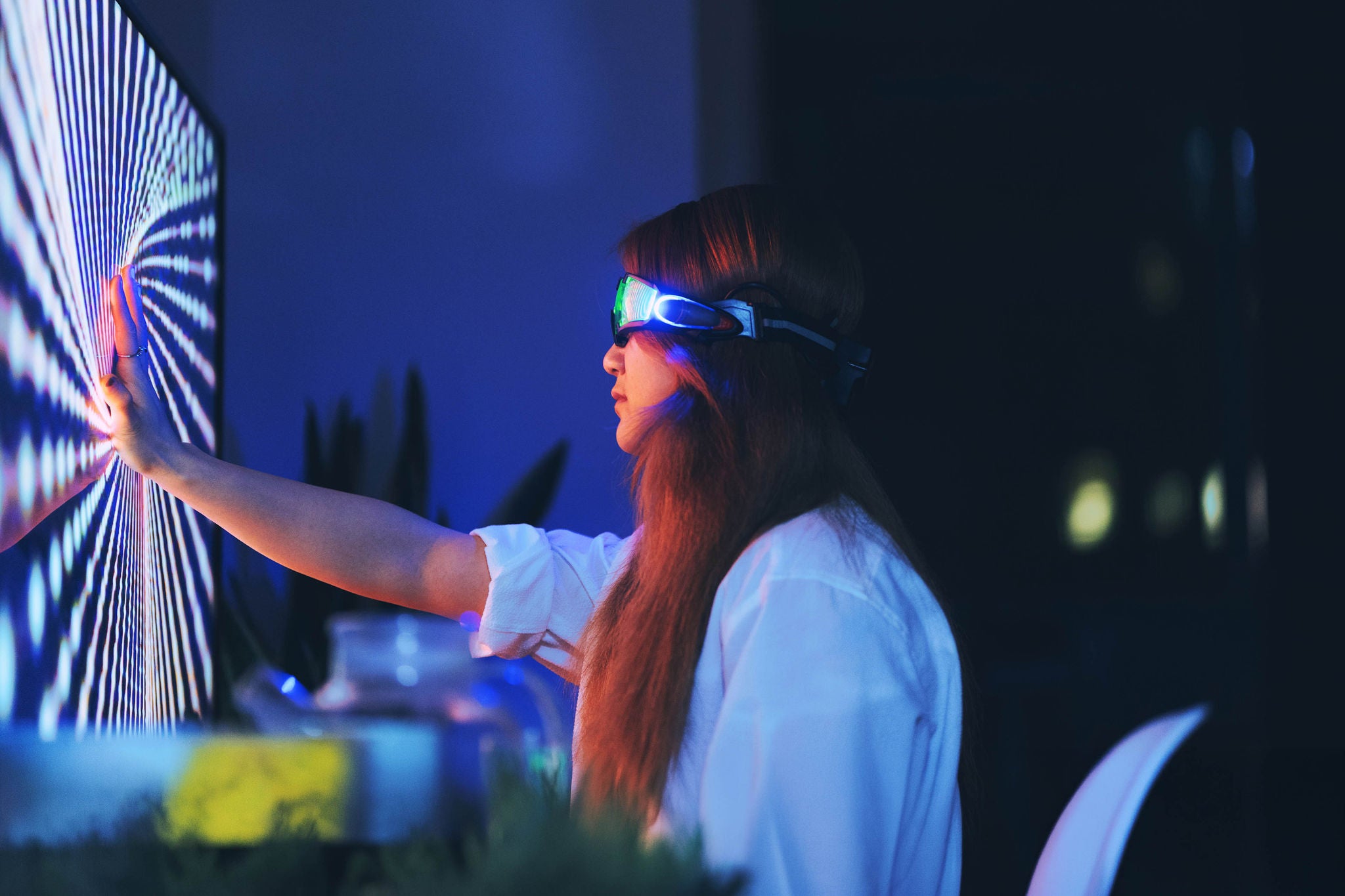 woman wearing augmented reality glasses touching screen