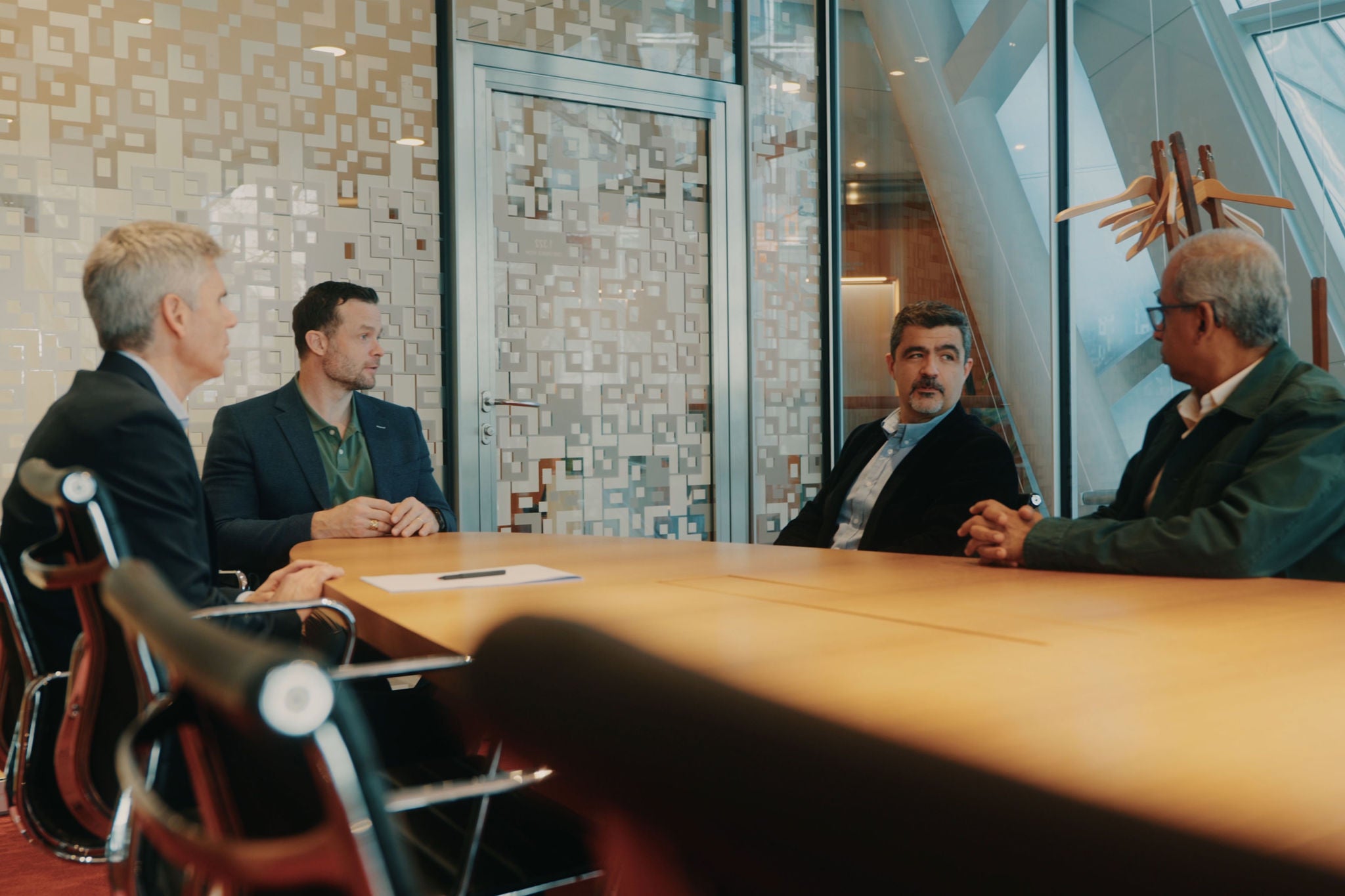 Group of people sat in a meeting room at the Novartis office