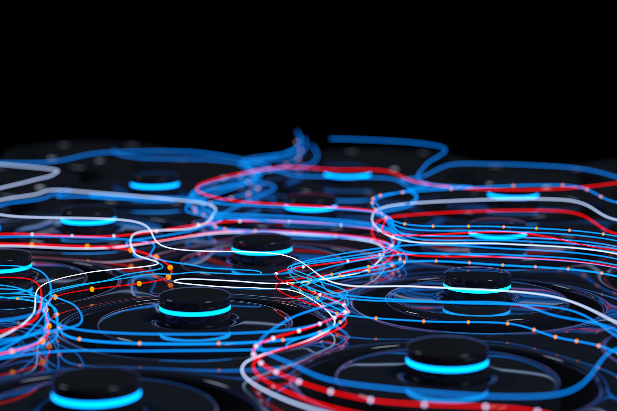 High angle rear view of male programmer coding on laptop while sitting at desk in startup office