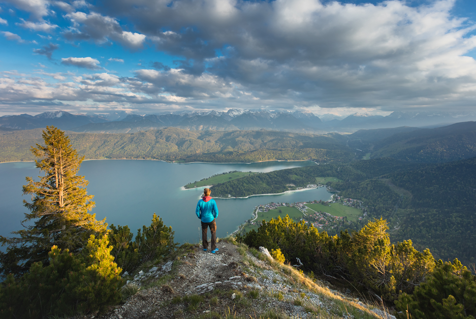 Man looking over a lake in the Barvarian mountains