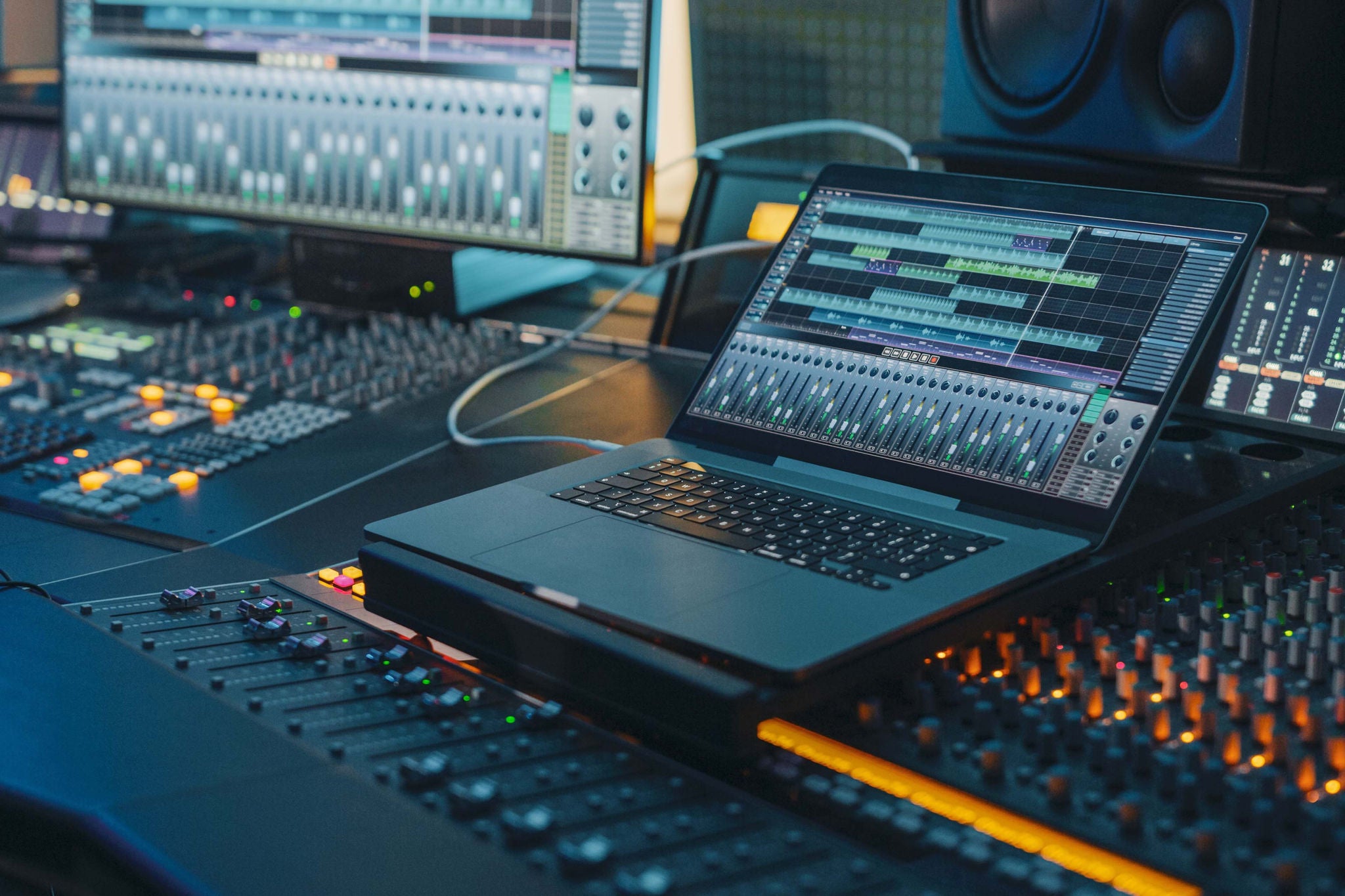Music record studio control desk with laptop screen