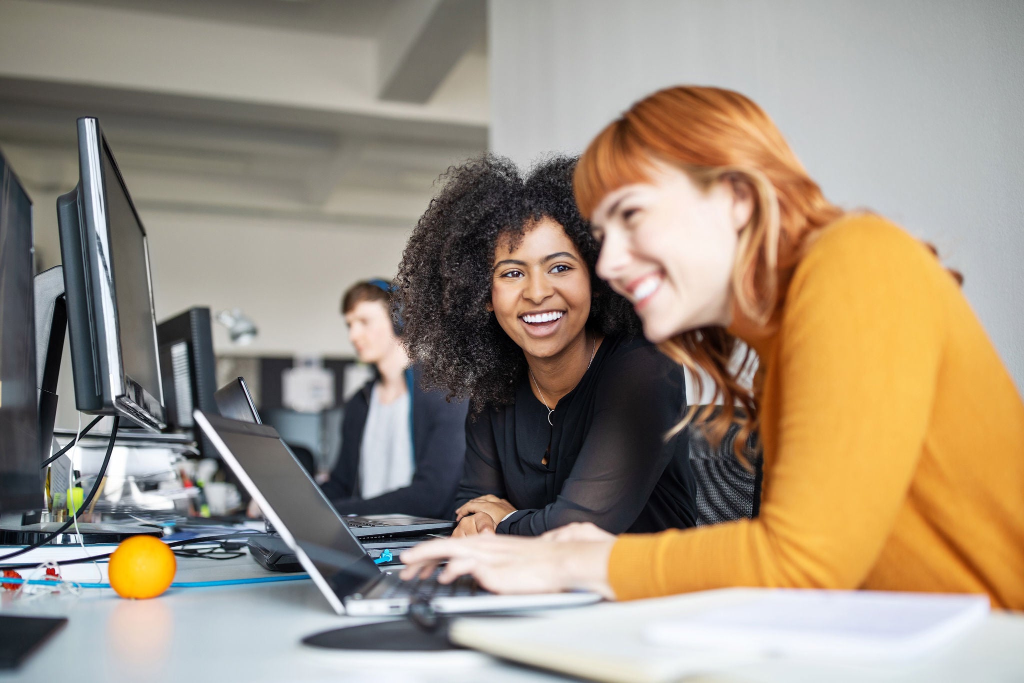 Two young women working together 