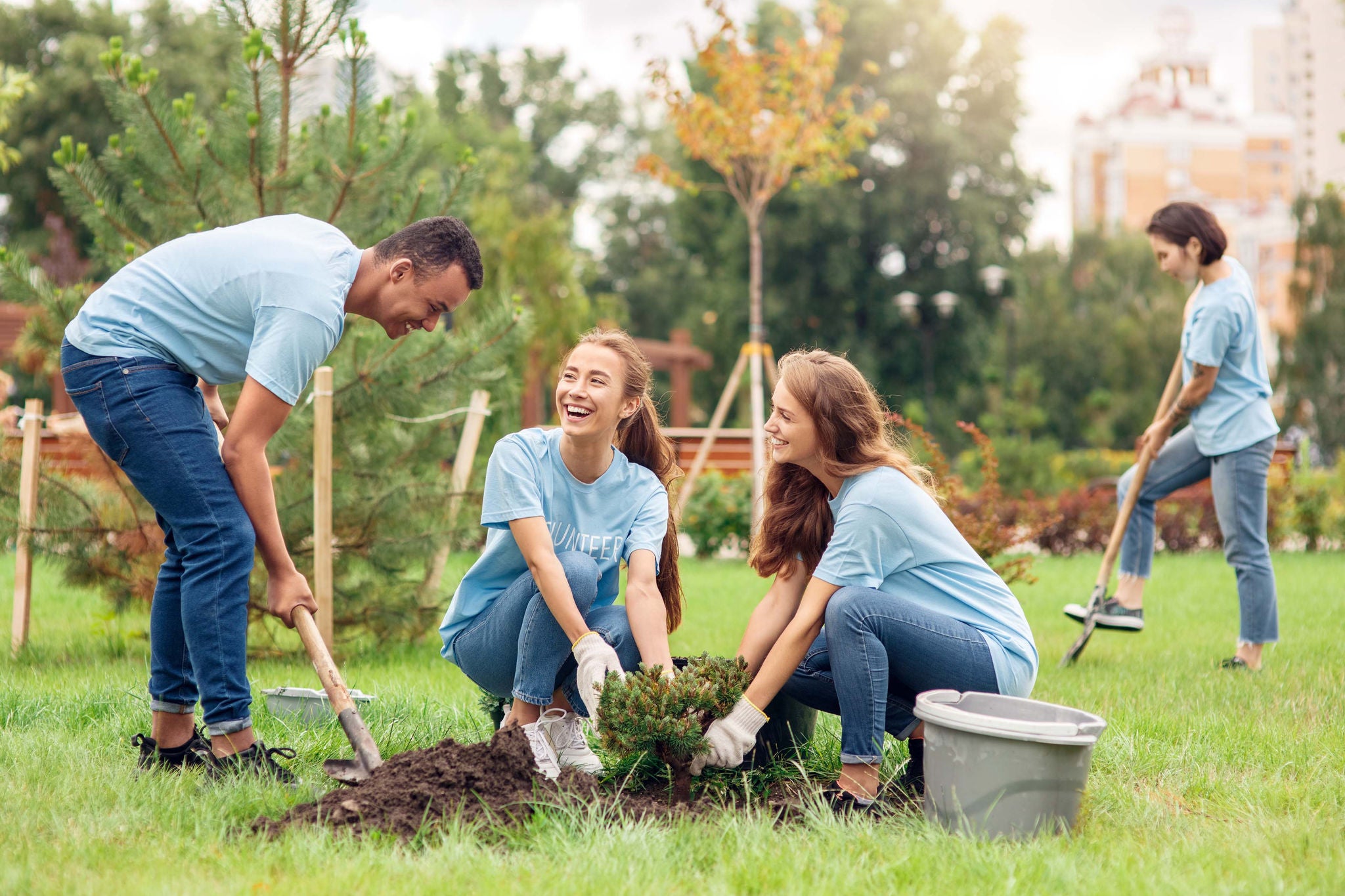 Young volunteers outdoors planting trees