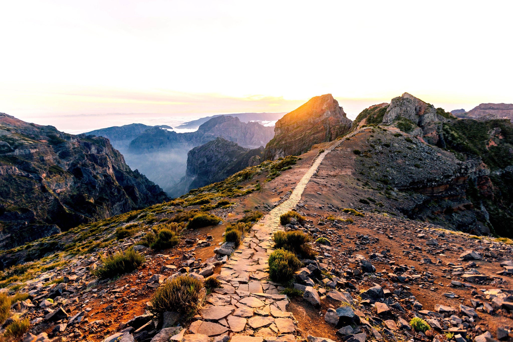 Mountaintop view, rocky path with haze and sunset