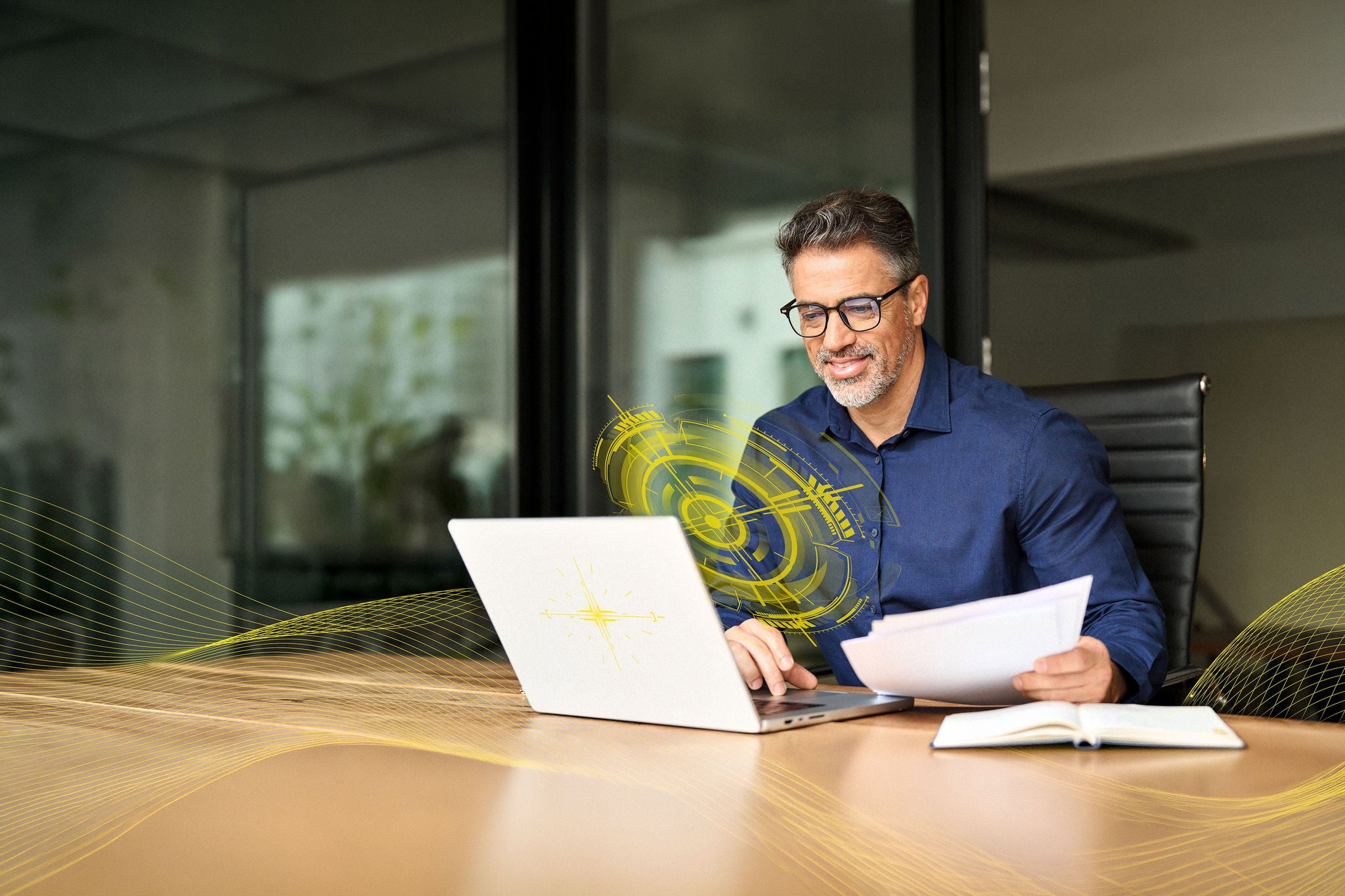 Man working on laptop while sitting in kitchen at home