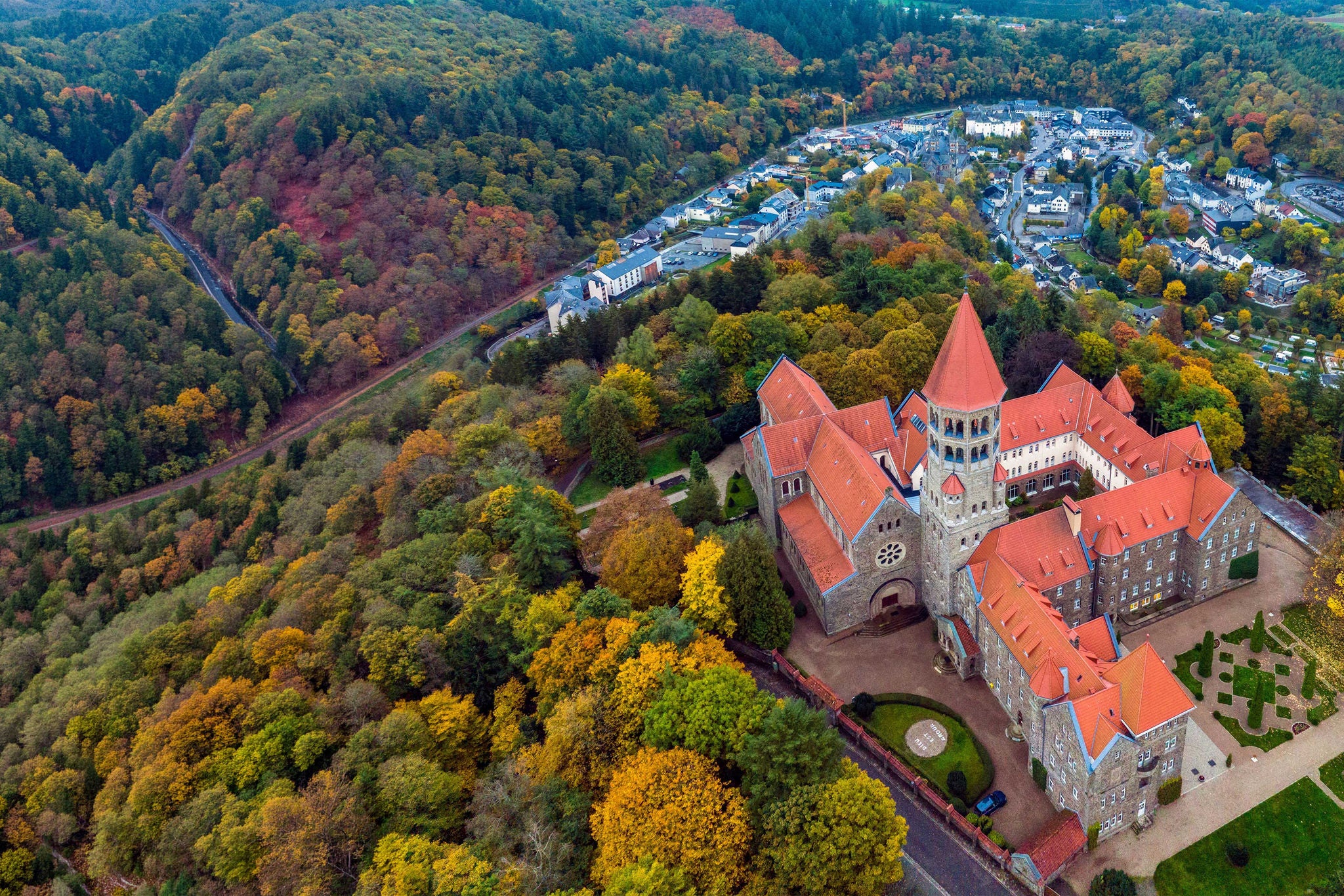 Aerial drone Shot of Abbey in Clervaux, Luxembourg in mystery evening twilight 