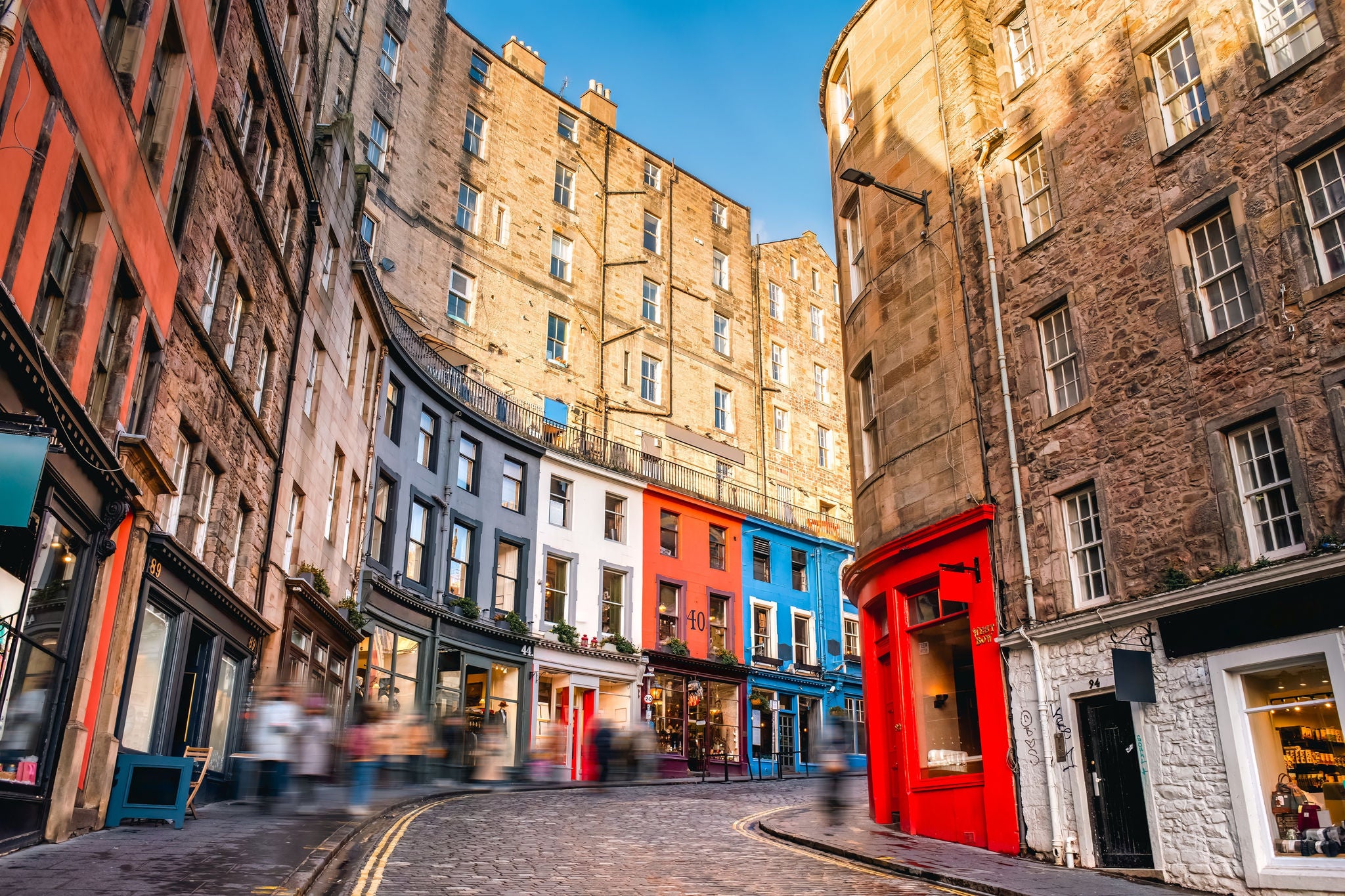Colorful curved street with historic buildings and shops